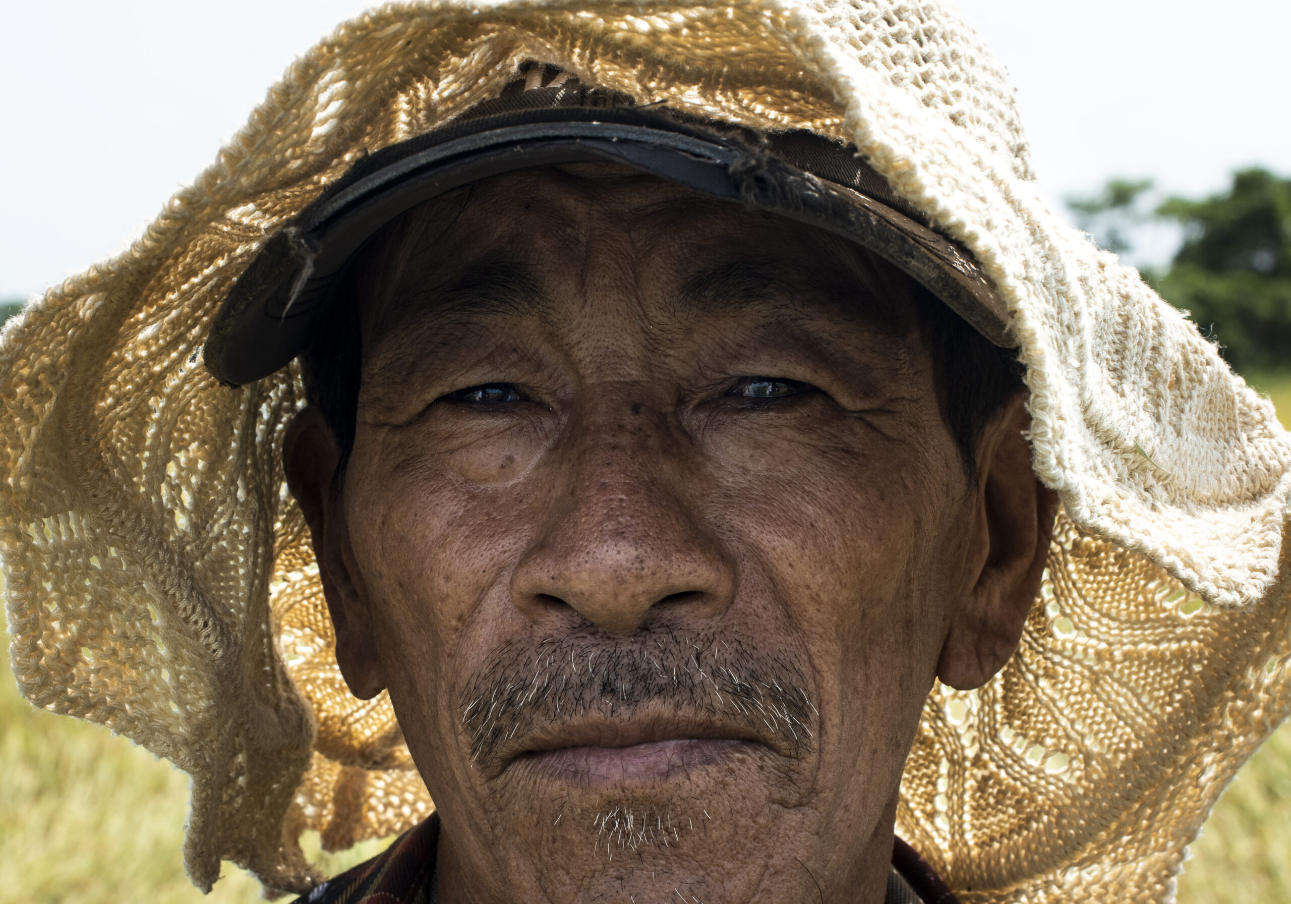 Rise field worker posing during his break in Cam Kim island in Vietnam